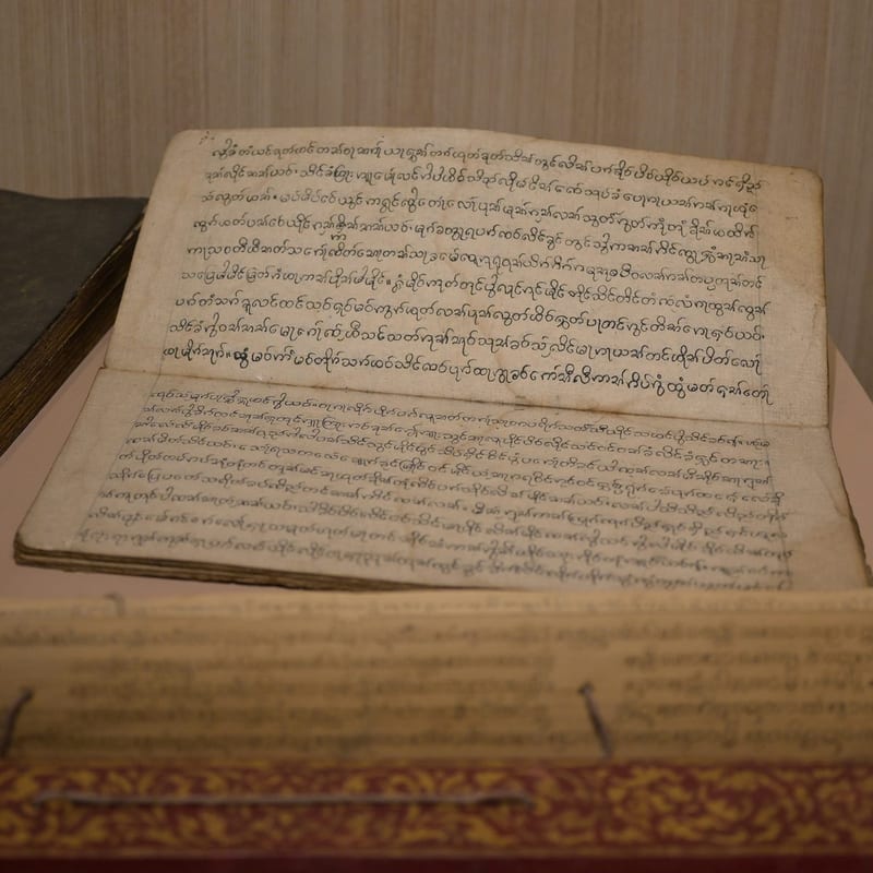 An ancient open manuscript with handwritten text and aged pages, representing the patristic exegetical tradition