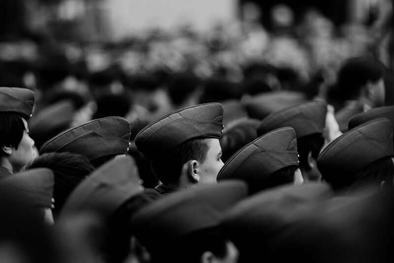 Rows of service members at an Army commissioning and graduation ceremony.