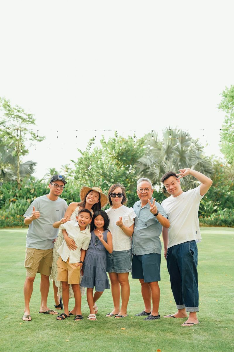 A multigenerational family poses for a group portrait outdoors