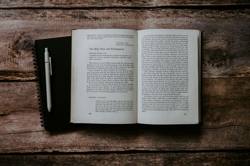 An open theological book on a rustic wooden table, evoking careful study of Scripture and the question of biblical inerrancy