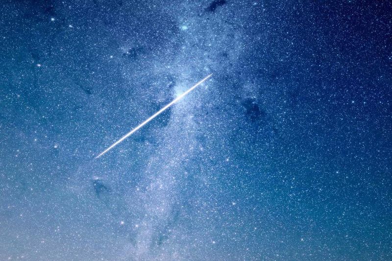 A bright meteor streaking across the Milky Way — an evocative visual for the GST tax concept of a transfer that 'skips' an entire generation of the family.